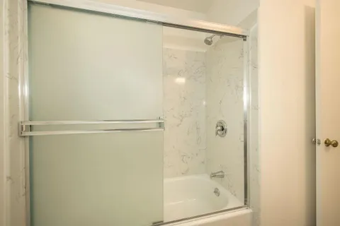 a bathroom with a glass shower door