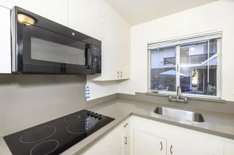a kitchen with a sink stove and microwave