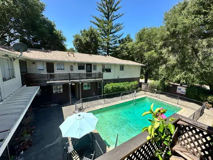 a view of a chairs and table on the wooden deck