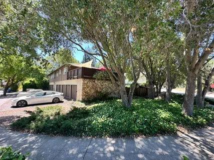 a front view of a house with a yard and fountain