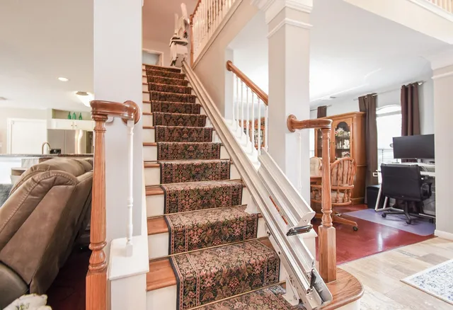 a living room with furniture and kitchen view