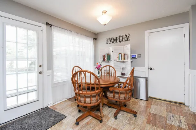 a en suite bathroom with a granite countertop double vanity sink mirror and bathtub