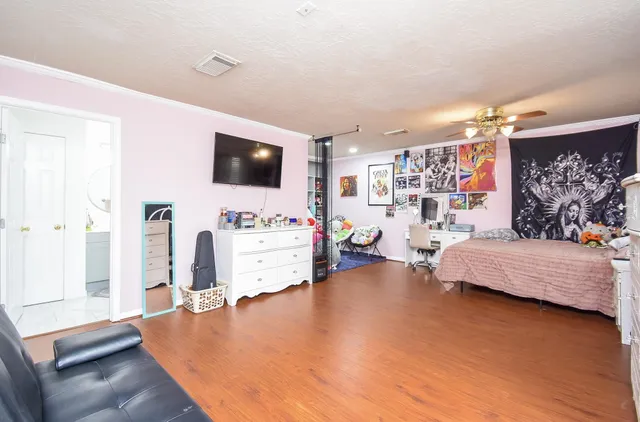 a living room with furniture and book shelf