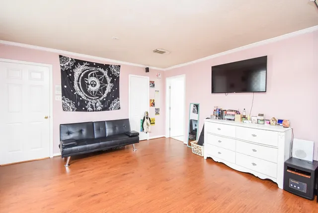 a bedroom with a bed and a flat screen tv