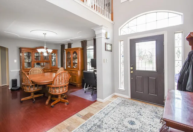 a living room with furniture a rug and a chandelier