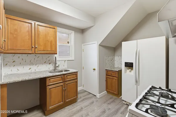 a kitchen with a refrigerator sink and stove