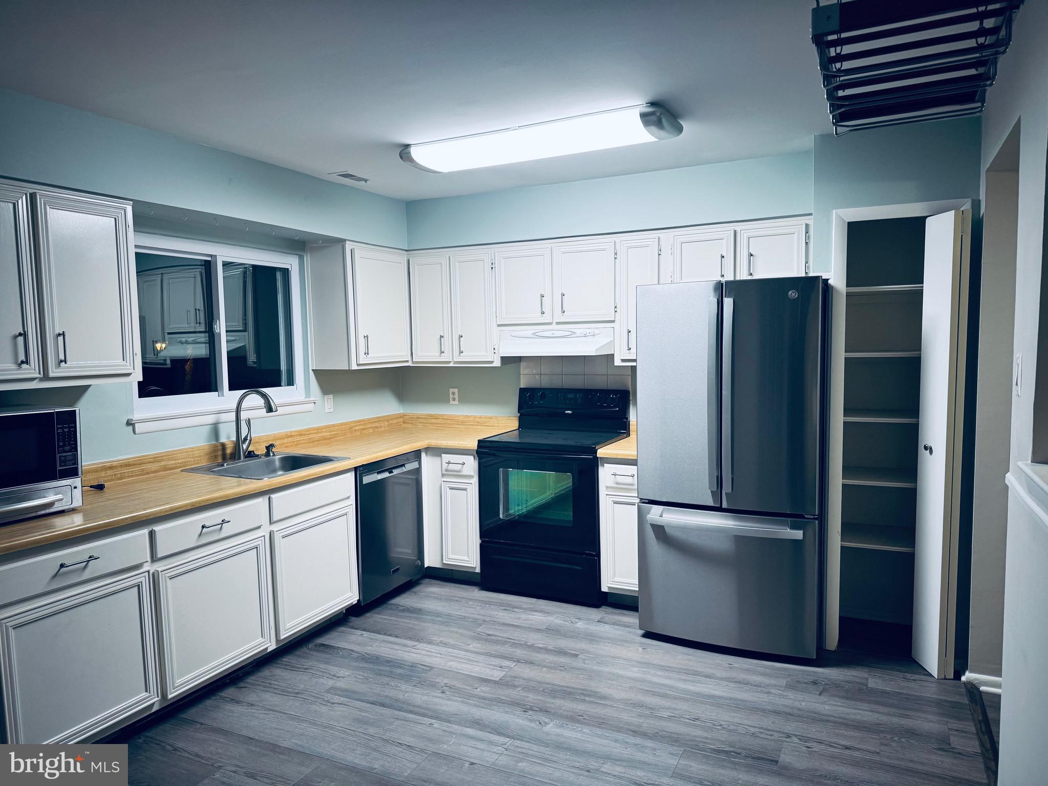 a kitchen with a refrigerator and a sink