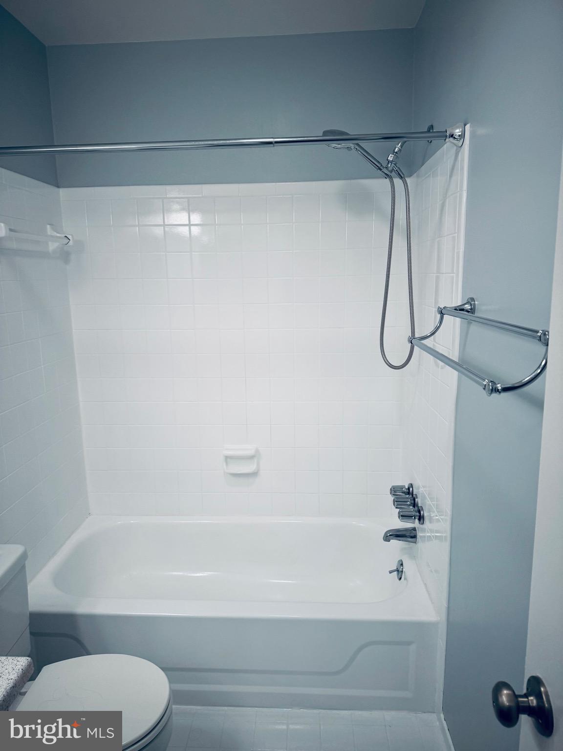 15839 Millbrook Lane, Unit 122 Laurel, MD 20707 - Photo 11 of 19 a bathroom with a shower and a white bath tub