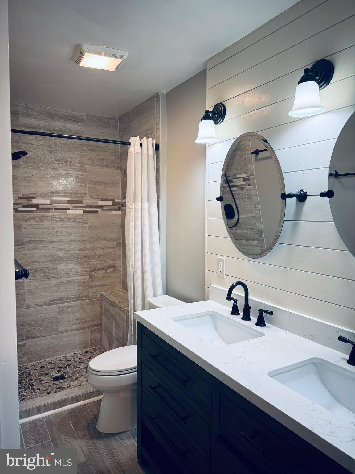 15839 Millbrook Lane, Unit 122 Laurel, MD 20707 - Photo 15 of 19 a bathroom with a sink and a mirror