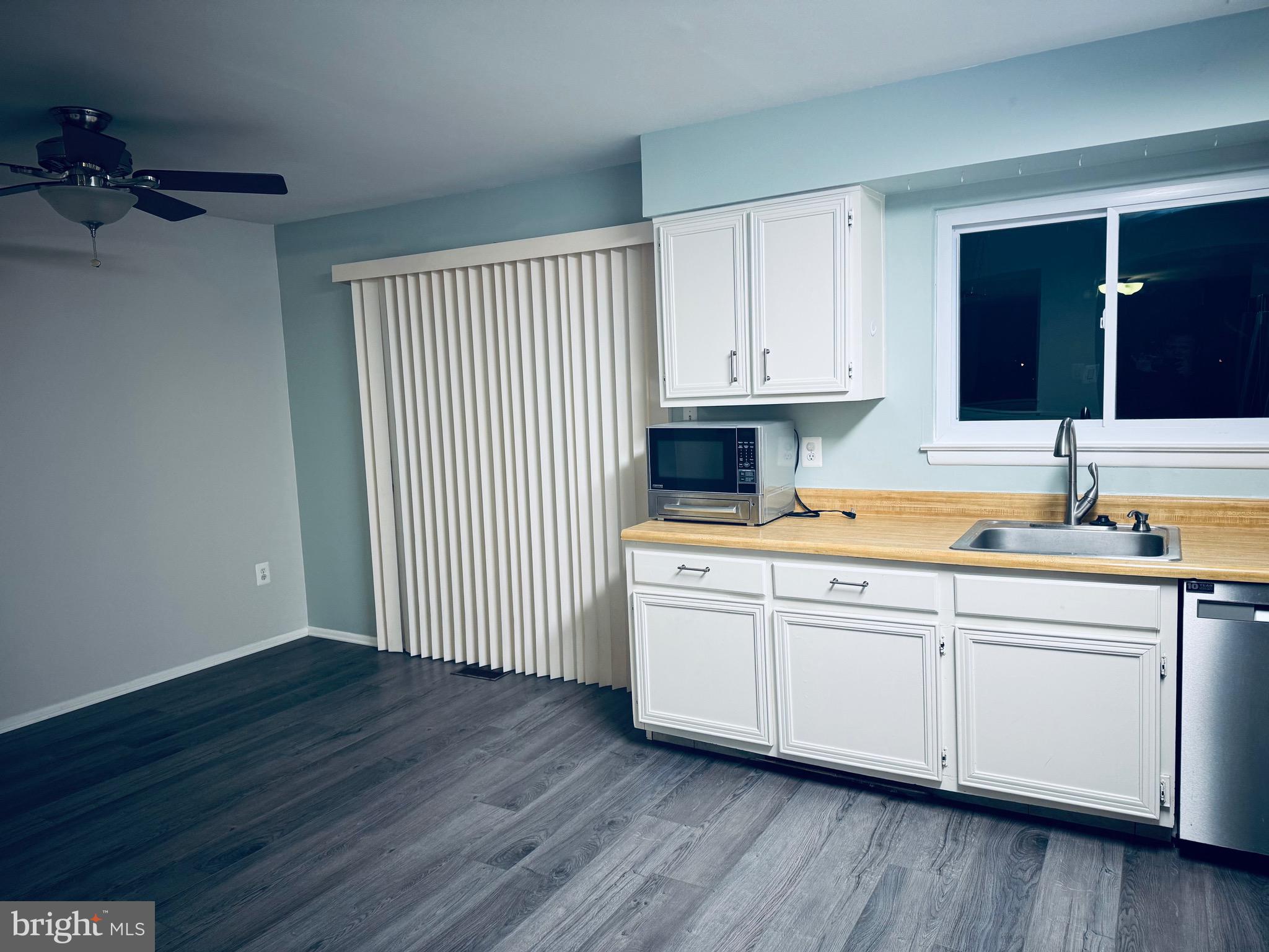 15839 Millbrook Lane, Unit 122 Laurel, MD 20707 - Photo 8 of 19 a kitchen with stainless steel appliances granite countertop a sink and cabinets with wooden floor