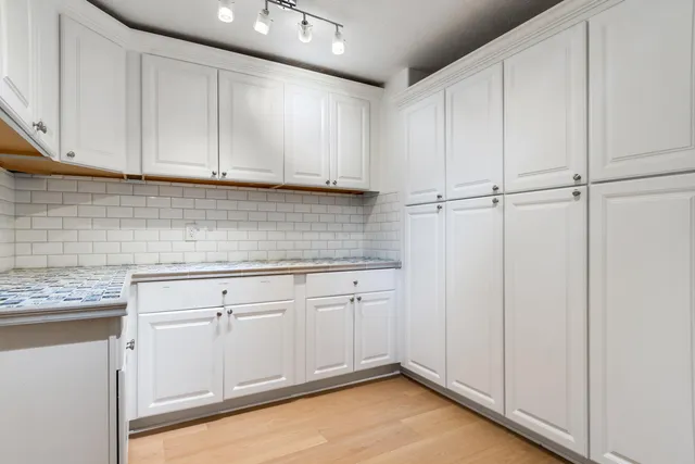 a kitchen with white cabinets