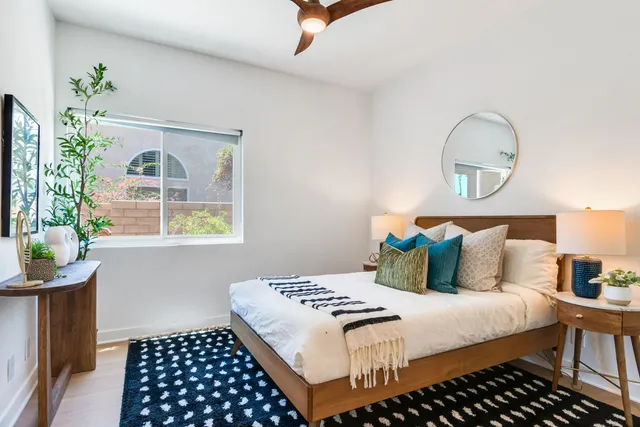 a bedroom with a bed and a window