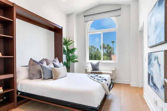 a bedroom with a bed and a window