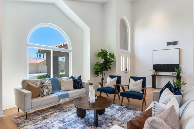 a living room with furniture and a potted plant