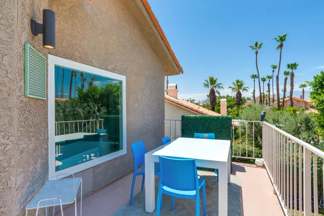 a view of a patio with table and chairs with wooden floor and fence
