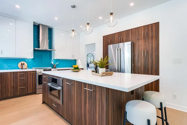 a kitchen with a table chairs sink and cabinets