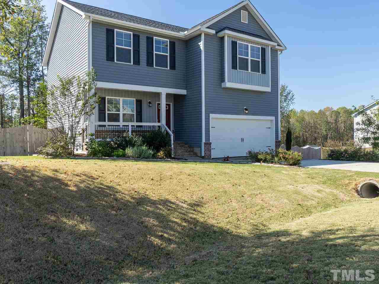 1132 Silver Farm Road Raleigh, NC 27603 - Photo 1 of 11 a front view of a house with a yard