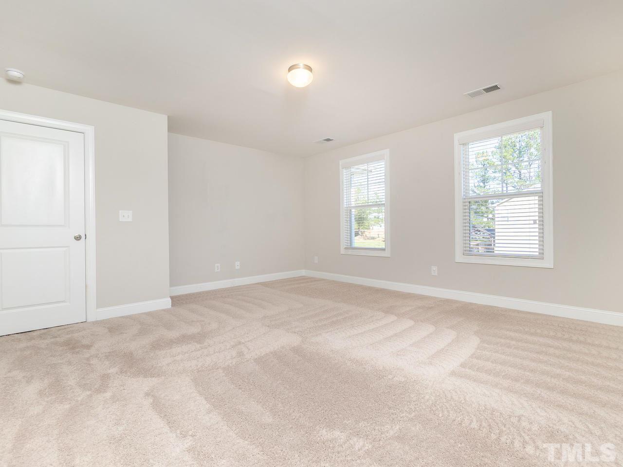 1132 Silver Farm Road Raleigh, NC 27603 - Photo 6 of 11 an empty room with windows
