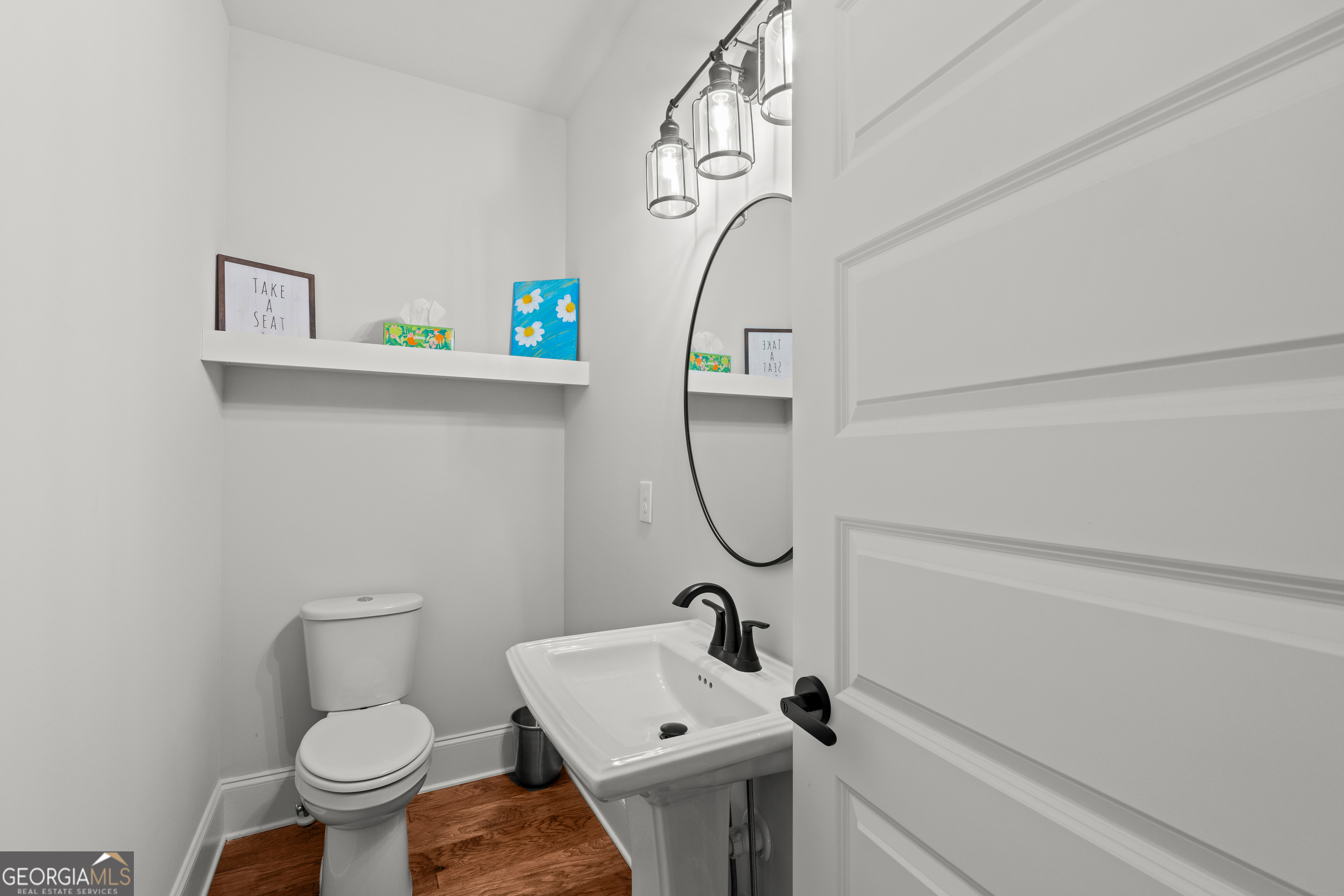 688 Central High Road Carrollton, GA 30116 - Photo 28 of 40 a bathroom with a sink a toilet and a mirror