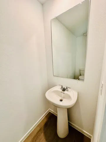 a view of a kitchen with furniture and wooden floor