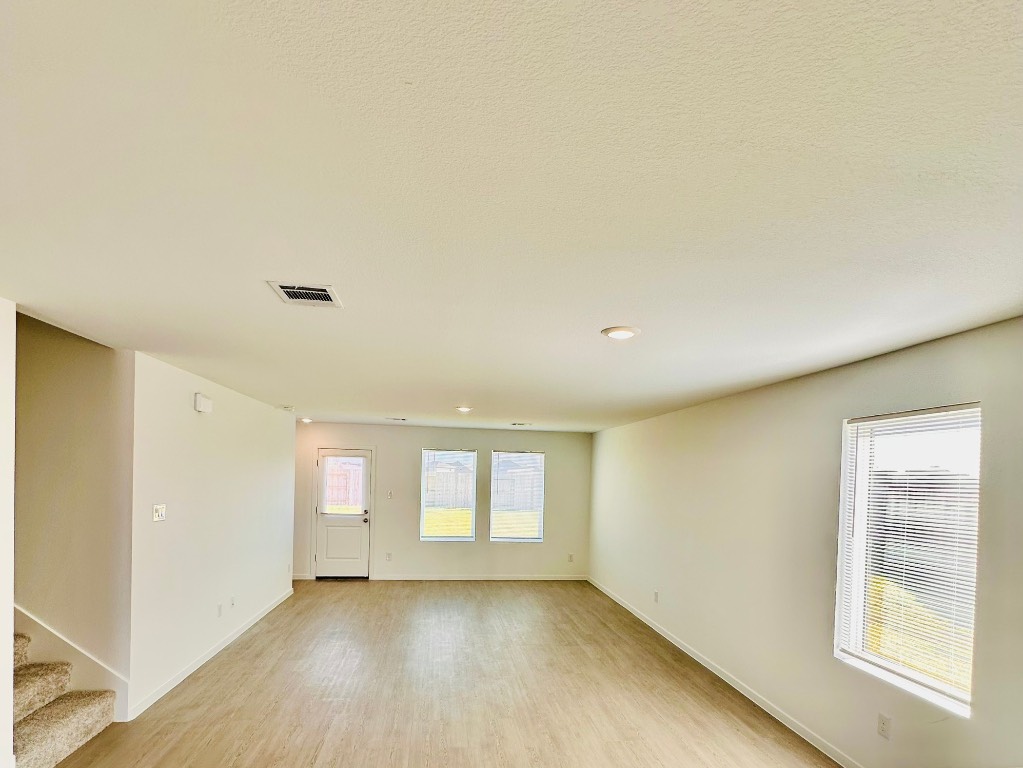 3041 Merganser Rdg Drive Katy, TX 77493 - Photo 6 of 28 a view of an empty room with a window and wooden floor