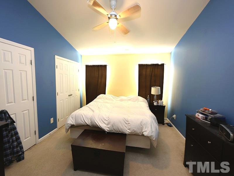 1402 Holly Grove Way Durham, NC 27713 - Photo 12 of 19 a bedroom with a bed and dresser with mirror