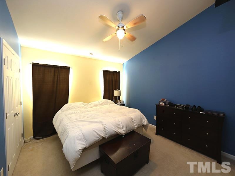 1402 Holly Grove Way Durham, NC 27713 - Photo 13 of 19 a bedroom with a bed and a chandelier