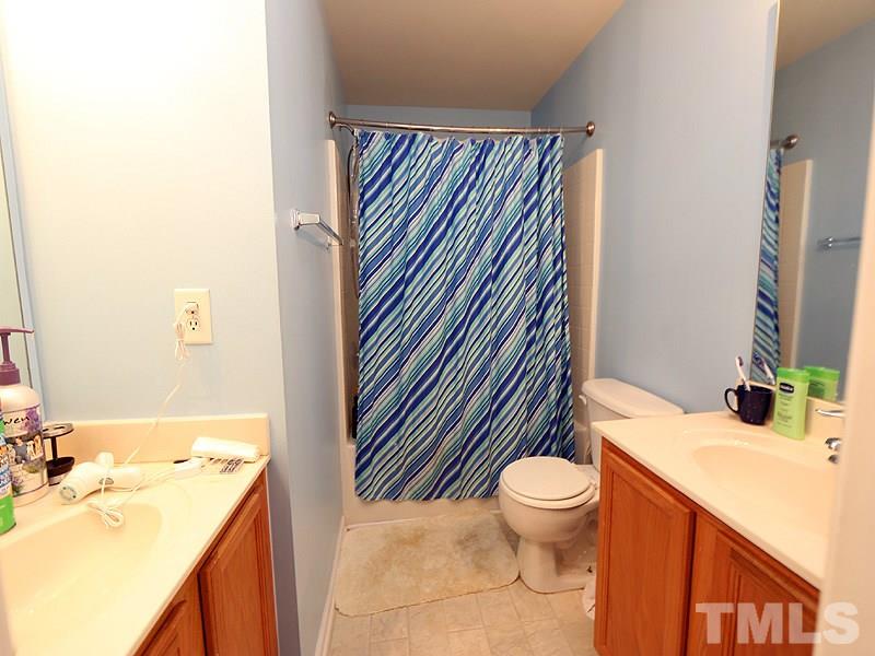 1402 Holly Grove Way Durham, NC 27713 - Photo 14 of 19 a bathroom with a sink a toilet and a mirror