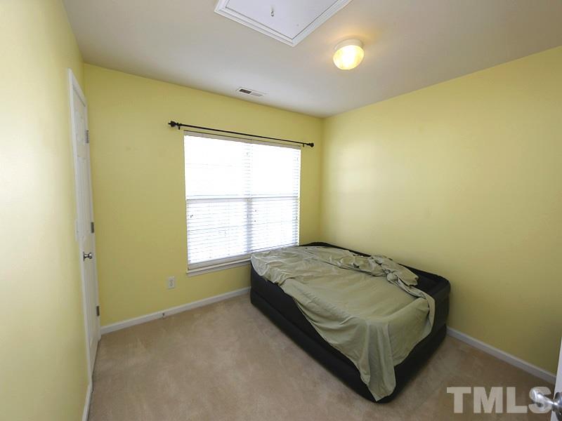 1402 Holly Grove Way Durham, NC 27713 - Photo 15 of 19 a bedroom with a bed and a window