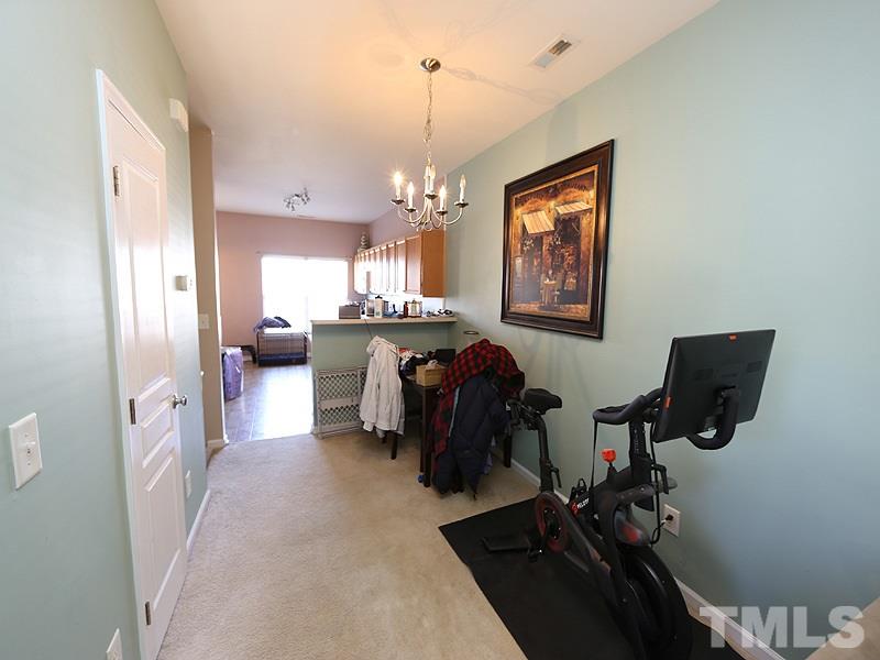 1402 Holly Grove Way Durham, NC 27713 - Photo 7 of 19 a living room with furniture and a chandelier