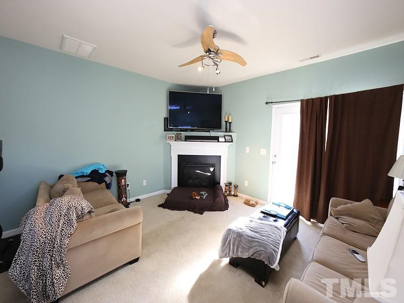 1402 Holly Grove Way Durham, NC 27713 - Photo 9 of 19 a living room with furniture and a flat screen tv