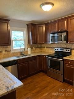 1316 Mayberry Road Dallas, NC 28034 - Photo 12 of 23 a kitchen with stainless steel appliances granite countertop a stove microwave and sink
