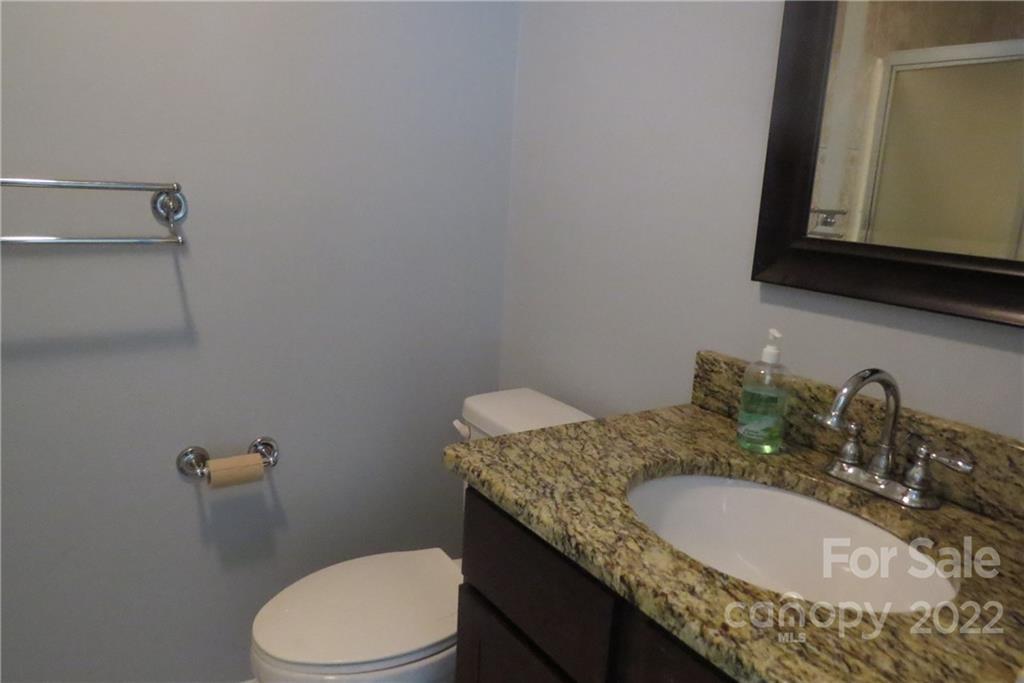 1316 Mayberry Road Dallas, NC 28034 - Photo 16 of 23 a bathroom with a granite countertop sink and a mirror