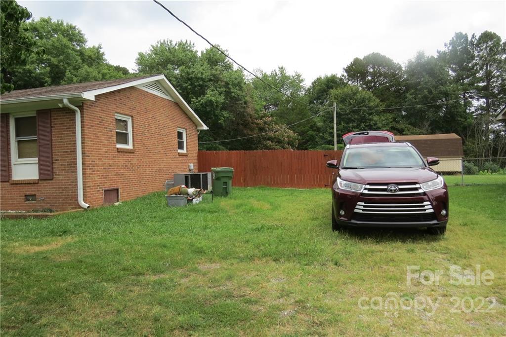 1316 Mayberry Road Dallas, NC 28034 - Photo 7 of 23 a view of a backyard with plants and a garden