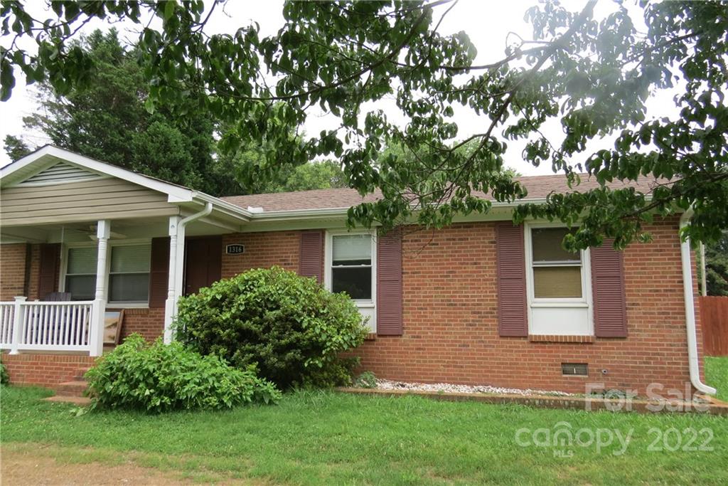 1316 Mayberry Road Dallas, NC 28034 - Photo 8 of 23 a front view of a house with a garden and yard
