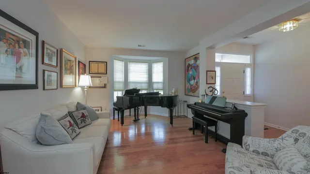 a living room with furniture and a piano