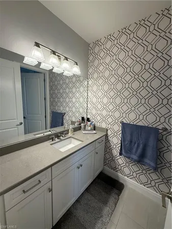 a bathroom with a double vanity sink mirror and