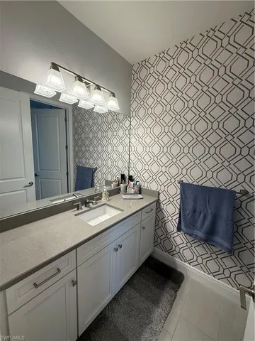 a bathroom with a double vanity sink mirror and