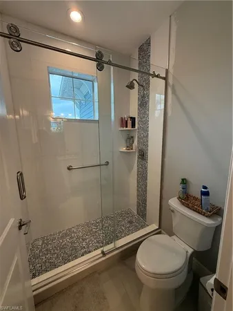a bathroom with a toilet and a shower