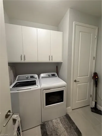 a view of a storage and utility room with washer and dryer