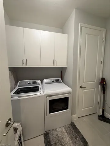 a view of a storage and utility room with washer and dryer