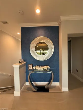 a room with a wooden floor and a potted plant