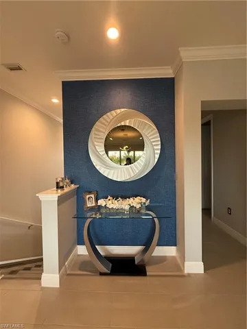 a room with a wooden floor and a potted plant
