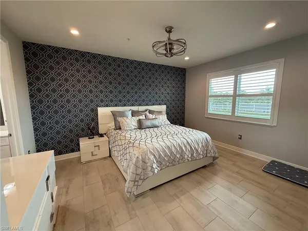a bedroom with a bed and a chandelier