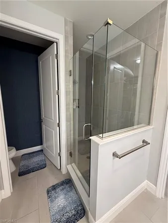 a bathroom with a shower and a sink
