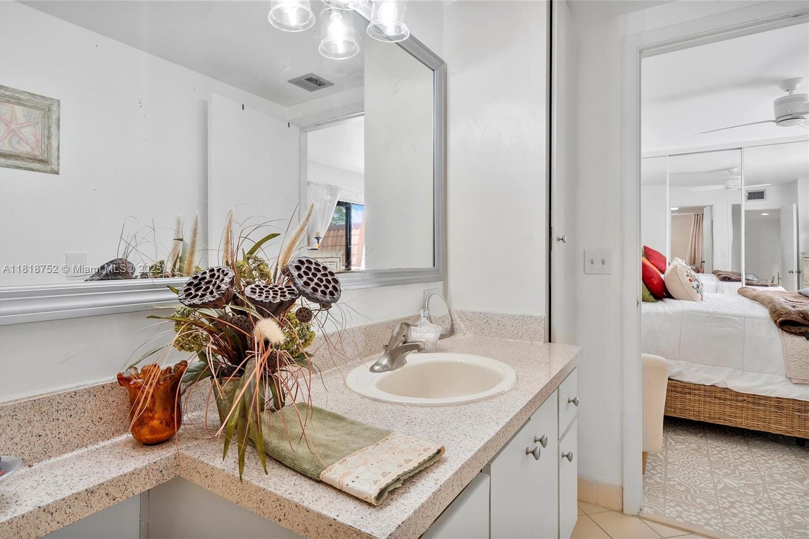 839 Blue Ridge Circle, Unit 839 West Palm Beach, FL 33409 - Photo 11 of 34 a en suite bathroom with a sink and a mirror