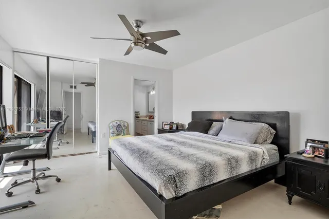 a bedroom with a bed a desk and chair