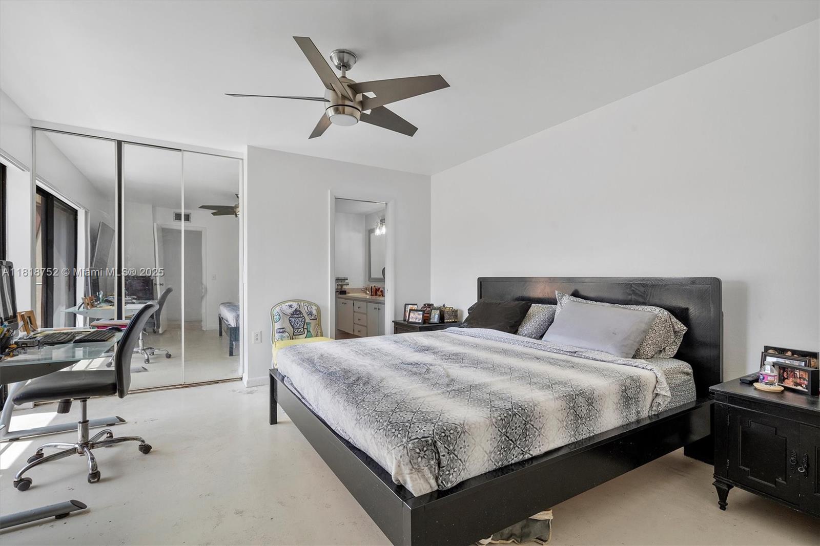 839 Blue Ridge Circle, Unit 839 West Palm Beach, FL 33409 - Photo 12 of 34 a bedroom with a bed a desk and chair