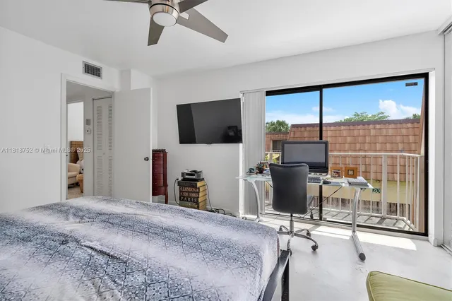a view of a livingroom with furniture and a flat screen tv