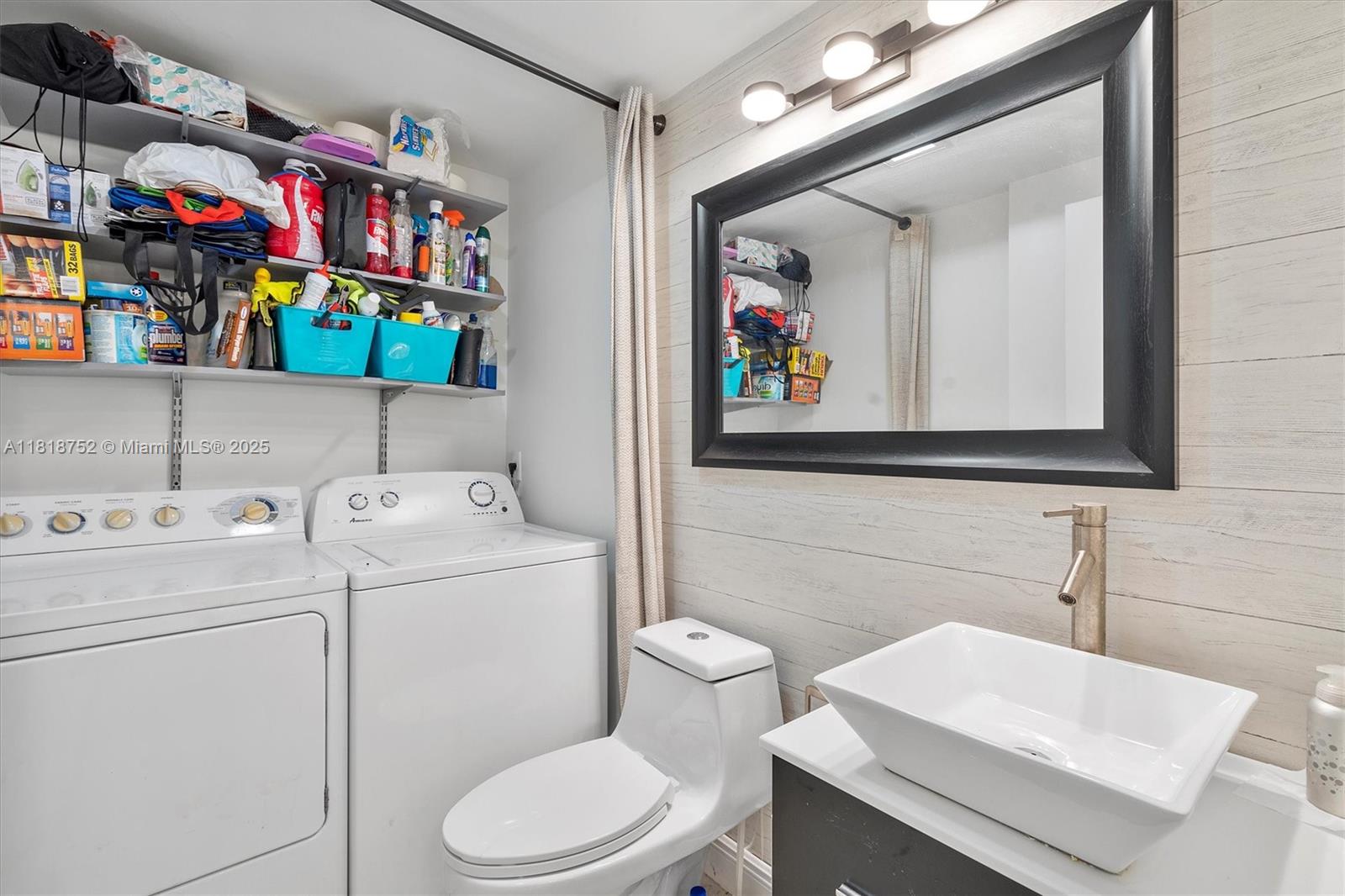 839 Blue Ridge Circle, Unit 839 West Palm Beach, FL 33409 - Photo 16 of 34 a bathroom with a sink a toilet and a mirror